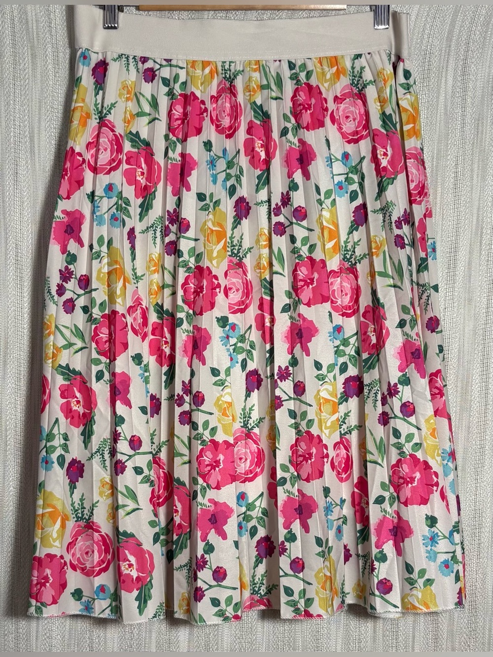 Metro Wear pleated midi skirt featuring a vibrant botanical floral print.